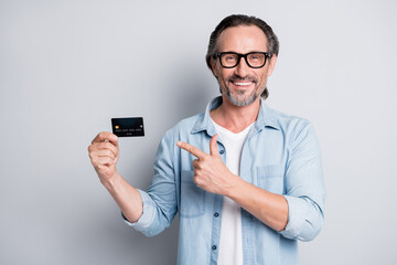 Photo of handsome man happy smile point finger credit card advice choice ad select suggest isolated...
