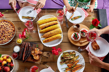 Top view over a dining table, decorated with flowers, family dinner.