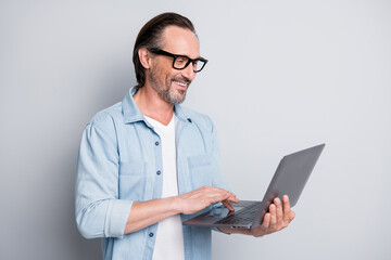 Profile side photo of cheerful man happy smile watch seminar laptop chat type email isolated over...