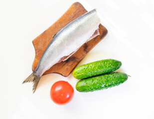 Norwegian herring on a board on a white table

