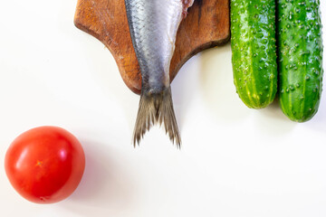 Norwegian herring on a board on a white table

