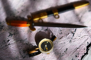 Selective  focus and blur of compass and antique dagger of naval officers. Shadow and light. Male...