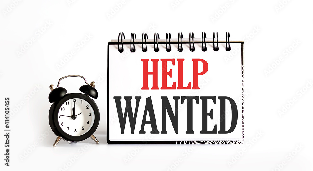 Aufkleber help wanted. notepad writing on the white background with alarm clock