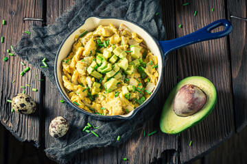 Closeup of fresh fried eggs with chive and avocado
