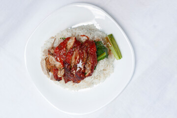 Top view of Rice with roast duck on top in a white plate at the restaurant.