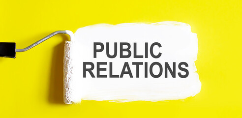 Public Relations . One open can of paint with white brush on it on yellow background.