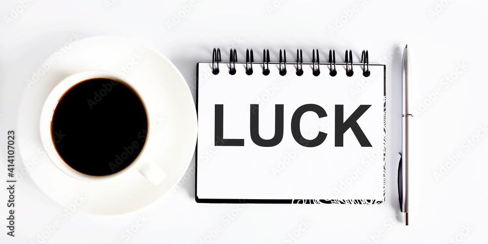 Poster luck . spiral notebook with text on the white background with coffee