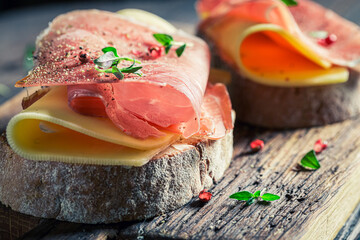 Fresh sandwich with cheese, ham and herbs for breakfast