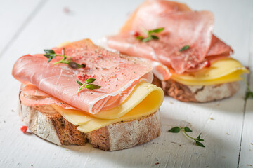 Fresh a piece of bread with cheese, ham and herbs