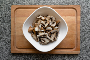 Top view of container with filleted mushrooms ready for cooking