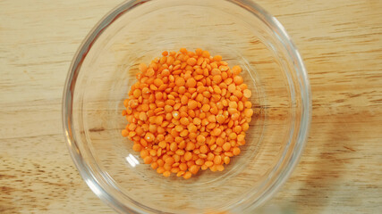 Pouring yellow lentils into a bowl. Close up shot