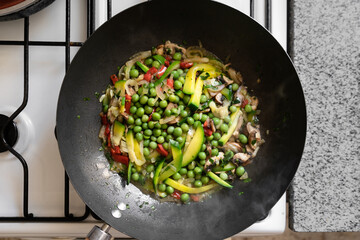 Top view of veggie wok in the stove. Healthy food concept.