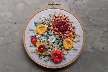 Floral embroidery on a gray concrete background 
