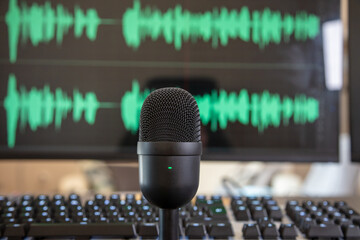 Black condenser microphone, mic blur turquoise waveform background.