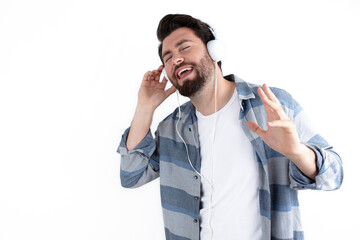 Portrait of happy young man listening to music with headphones