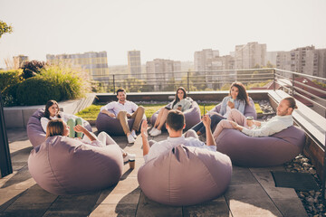 Photo of clerks professionals sitting bean bags listening lecture outside outdoors workplace...