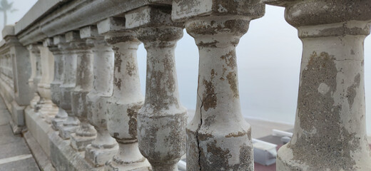 Panoramic shot of a balcony near a seashore under a foggy sky in Ceuta, Spain