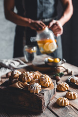 Man pours Hot tea with slices of fresh grapefruit on wooden tablet. Healthy drink, Eco, vegan.