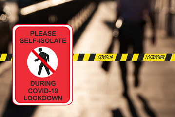 Concept ''Please self-osolate during COVID-19 lockdowm'' against a quarantine tape and defocused walking man