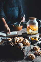 Woman cooks in a vintage kitchen on wooden tablet. Healthy drink, Eco, vegan.