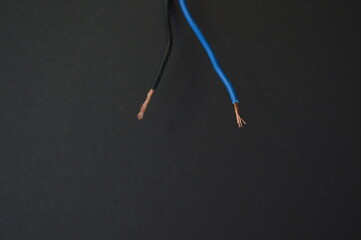 two wires with electricity on a black background