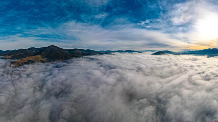mountains tops high above clouds fog