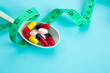 Measuring tape and pills for dieting concept.