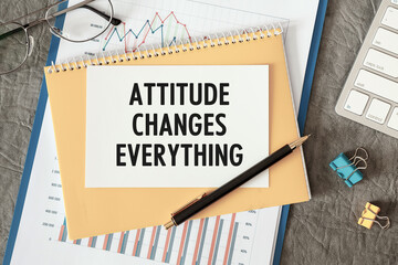 Attitude Changes Everything is written in a document on the office desk