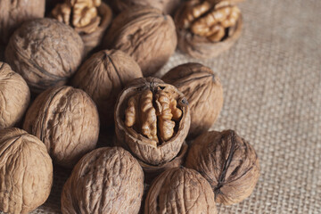 Walnuts lie on a sacking cloth whole and split