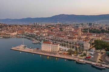 Fototapeta na wymiar Aerial drone shot of Diocletian Palace by port riva in Split old town before sunrise in early morning in Croatia