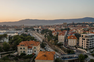 Split, Croatia - Aug 13, 2020: Aerial drone shot of railway near ferry port in sunset hour