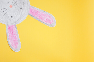 funny paper easter bunny on a yellow background.