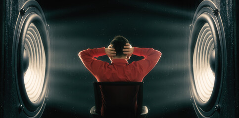 The man covers his ears from the powerful sound from the speakers.