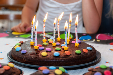 Little girl in front of a birthday cake