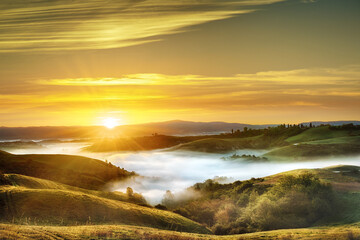 Idyllic view, foggy Tuscan hills in light of the rising sun