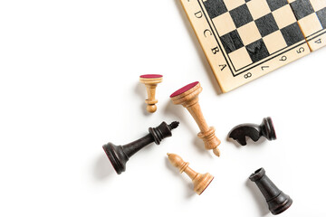 Flat lay composition with chess pieces and chessboard isolated on white background with copy space. © Алексей Коза