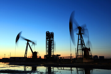 In the evening, oil pumps are running, Silhouette of beam pumping unit