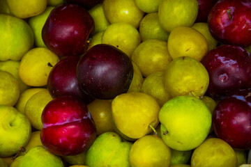 Ciruelas de diversos colores en un puesto callejero