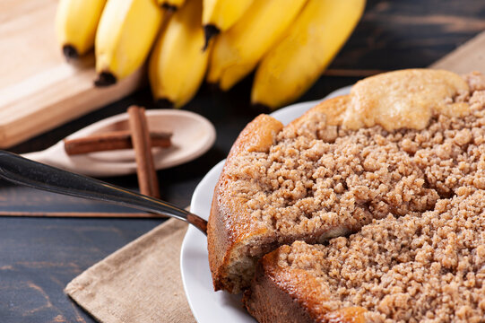 .Traditional Brazilian banana cake called "Cuca de Banana" With crispy topping and cinnamon - Kuchen. Selective focus