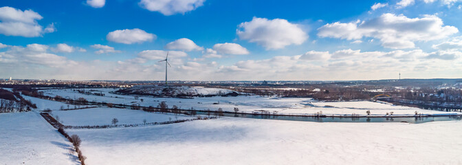 View of the snow-covered skyline of Duisburg on a sunny winter day from above