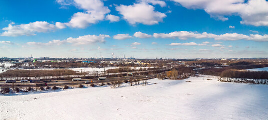 View of the snow-covered skyline of Duisburg on a sunny winter day from above