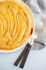 Inverted banana cake on a light background. View from above