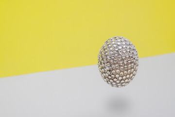 Festive easter flying egg on modern gray and yellow background