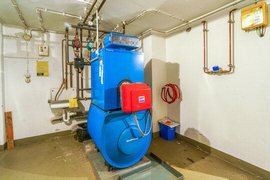 Old blue Buderus G 105 heating boiler with red Ray oil burner