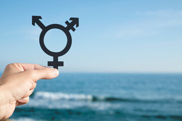 person showing a transgender symbol