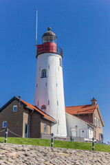 Fototapeta na wymiar Historic white lighthouse on top of the dike in Urk, Netherlands