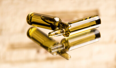 Medical ampoules on a beige background. Brown ampoules.