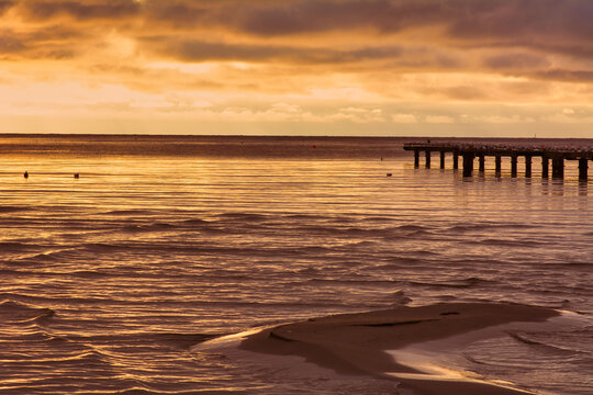 A sand bar with a beautiful ocean sunset in the background. Photo from Hallevik, Blekinge county, Sweden