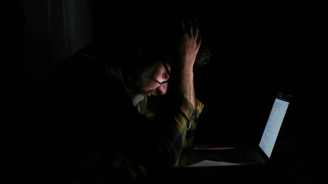 Tired and frustration man working and using laptop at late night. Business man upset to have work too much 
