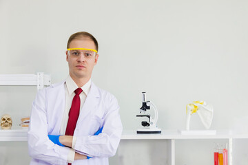 Male scientist wearing blue safety glasses and glove isolated